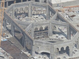 Sicht aus der Vogelperspektive auf ein großes, graues Gebäude, welches den Ceremonial Dome Mekka darstellt.